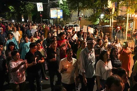 People during a candlelight march in protest against the alleged rape and murder of a trainee woman doctor at the RG Kar Medical College and Hospital, in Kolkata, Wednesday